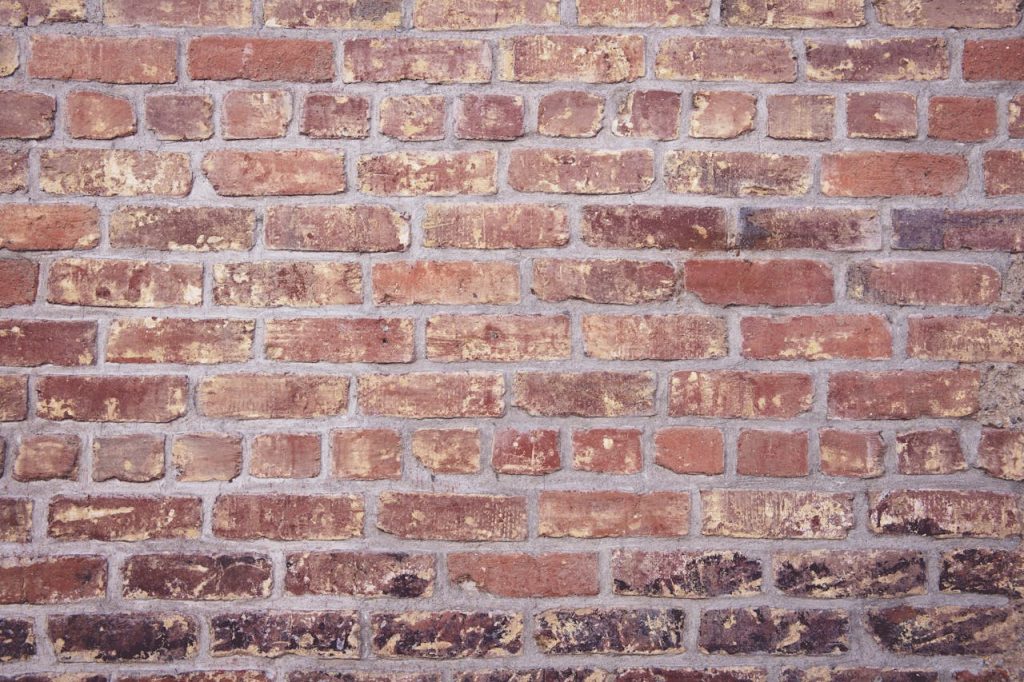 A close-up of a solid brick wall, symbolizing the emotional barrier of resentment that builds between partners.