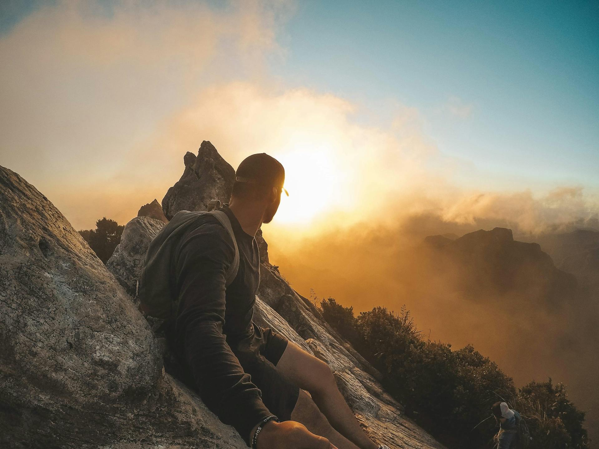 Neurodivergent (ADHD, ASD, HSP) man on mountain peak watching sunrise, symbolizing positive change and real-world results from ADHD counselling.